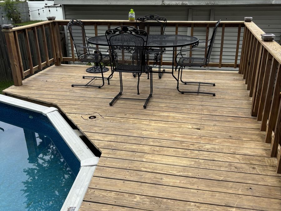 Pool deck after pressure washing — restored to natural wood tone